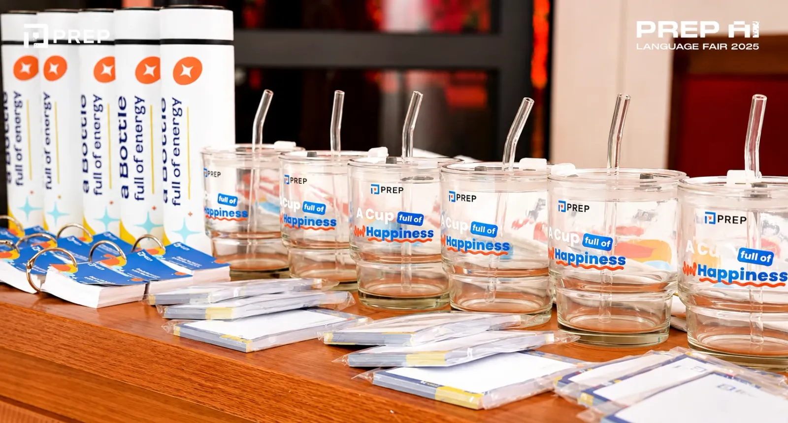 PREP bottles, glass cups, ring notebooks and notepads laid out at the event